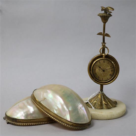 An 18ct gold dress watch contained in a Victorian mother of pearl and gilt metal watch stand modelled as a hinged egg